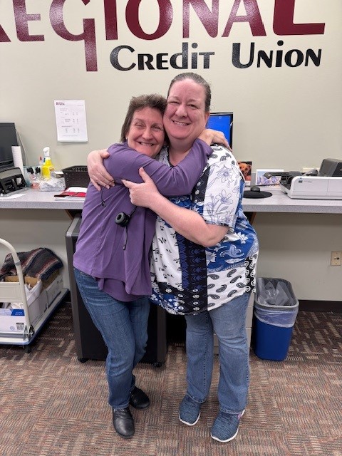 Two women being silly and hugging.